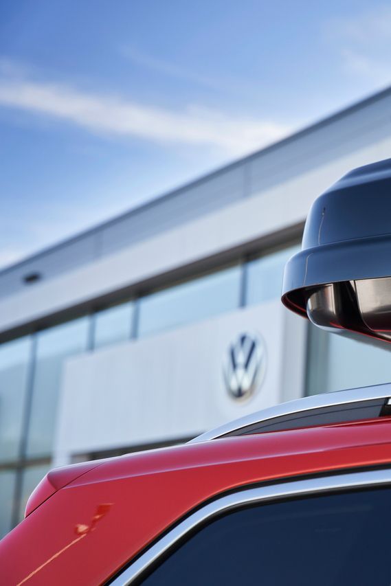 Eine schwarze Dachbox mit Volkswagen Schriftzug am Dach eines Volkswagen